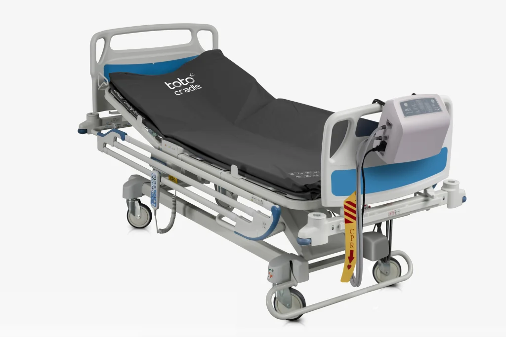 Toto Cradle on a hospital bed with its control unit.